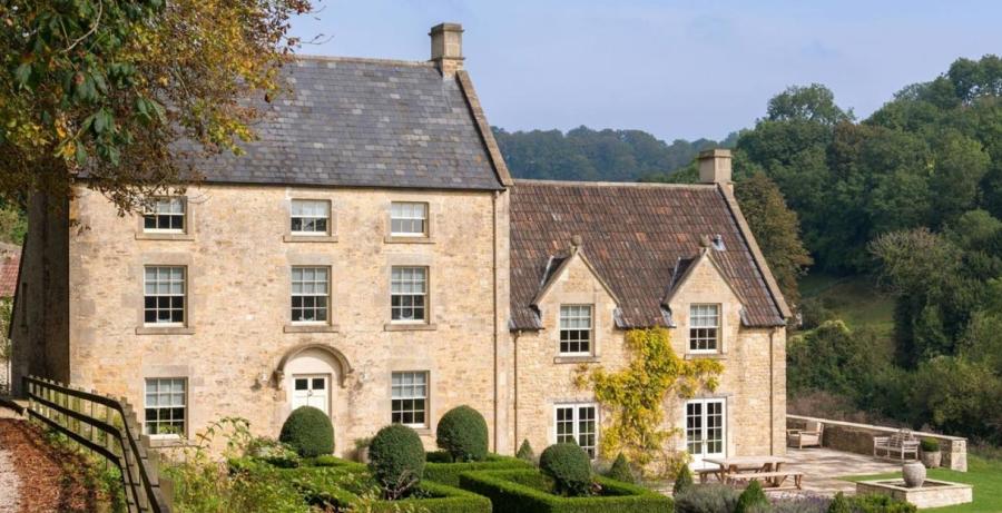A stunning farmhouse set amongst trees and landscaped gardens